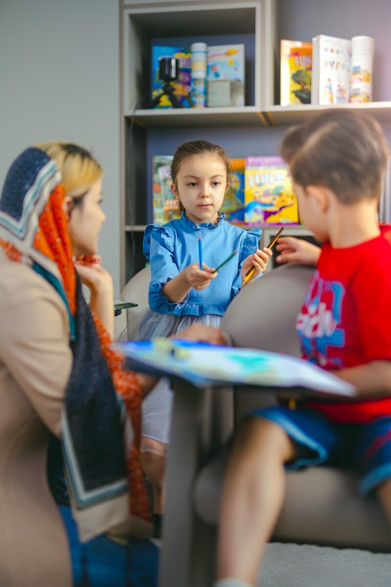 Children learning with a teacher in a classroom.